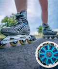 Person skating on pavement with focus on 90mm 85A Inline Skate Wheels Set Of 6 For Outdoor Replacement With Blue Core High Rebound PU.