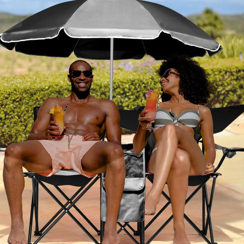 Two Person Folding Camping Chair With Adjustable Umbrella Built In Cooler at the beach with two people enjoying drinks