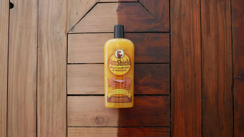 Bottle of Sun Shield Wood Wax With UV Protection For Outdoor Furniture Gallon, showing effect on wooden surface.