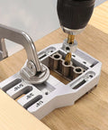Joint Master Doweling Jig With Self-Clamping Aluminum Frame for Edge, Corner and Surface Joints, drilling on wooden surface.