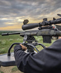 Stinger Adjustable Ambidextrous Rifle Shooting Rest with rifle setup in outdoor range, showcasing stability and steel tube frame.