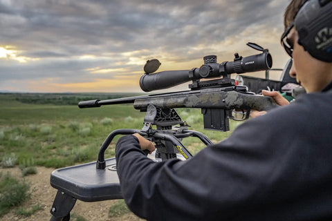 Stinger Adjustable Ambidextrous Rifle Shooting Rest with rifle setup in outdoor range, showcasing stability and steel tube frame.