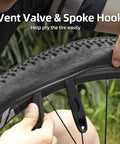 16 In 1 Foldable Bike Tool Kit For Cyclists, Portable Multitool With Allen Wrenches And Tire Levers shown prying bike tire