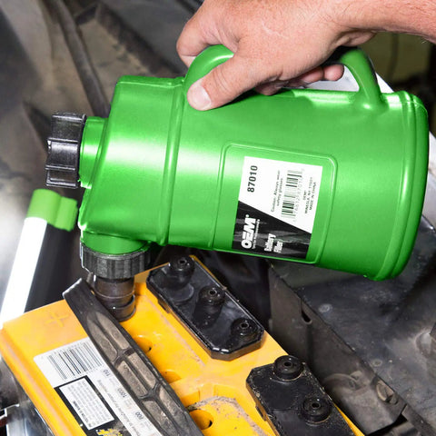 Person using green Battery Water Filler Jug With Auto Shutoff Nozzle 2 Liter Distilled Water Bottle For Lead Acid Batteries