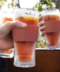 Set of two Freezable Pint Glasses Double Walled Insulated Tumblers with wooden handles, chilling drinks outdoors.