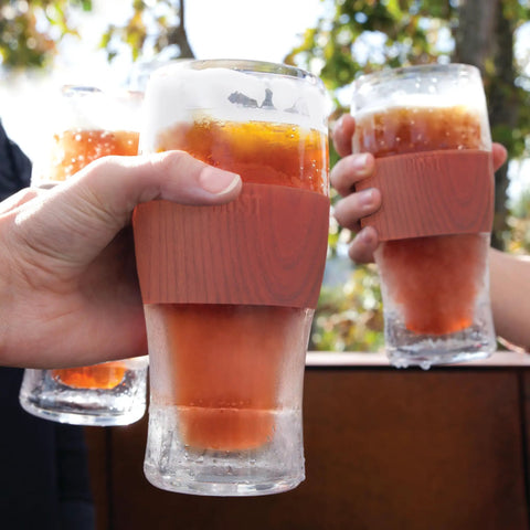 Set of two Freezable Pint Glasses Double Walled Insulated Tumblers with wooden handles, chilling drinks outdoors.