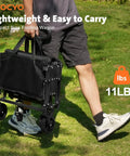 Man carrying a folded collapsible wagon cart 220lbs capacity foldable beach wagon lightweight portable utility cart with wheels