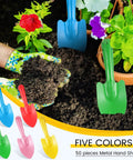 50 Piece Mini Colorful Metal Hand Shovels Set For Gardening Tiny Trowels Dope Digging Planting Transplanting And Soil Work Five Color Assortment Red Yellow Pink Blue Green For Women Men Kids, shown in garden soil with gloves.