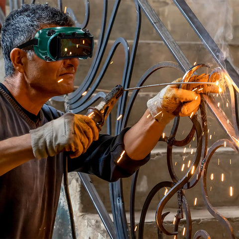 Built Like A Tank Welding Safety Goggles being worn by a welder, showcasing sparks and metalwork in action.