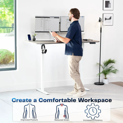 Upgrade Your Workspace With This Slick Dark Gray Standing Desk Measuring Sixty-Three By Thirty-Two Inches, shown in use with dual monitors.