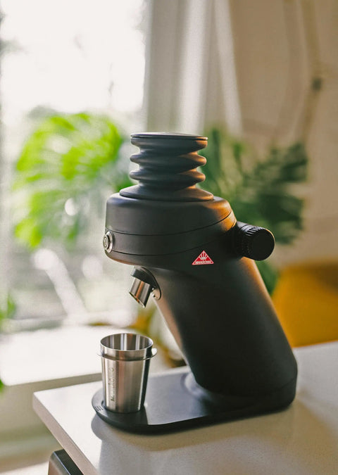 Game Changing Single Dose Coffee Grinder With 64 Millimeter Flat Burrs Stepless Adjustment, black design with stainless steel cup.