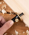 Hand holding Pro Grade Wheel Marking Gauge With Replacement Cutters, Woodworking Marking Scriber Kit against wood surface