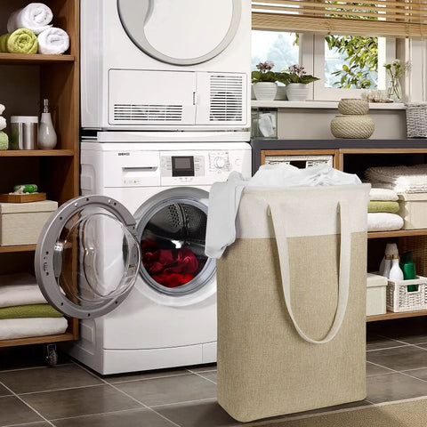 Two-Pack Slim Laundry Hampers Set In Beige And Khaki, Collapsible Linen-Like Fabric Baskets next to washing machine