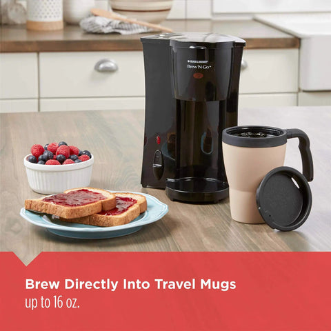 Black Compact Brew And Go Personal Coffee Maker With Travel Mug on kitchen counter next to toast and berries