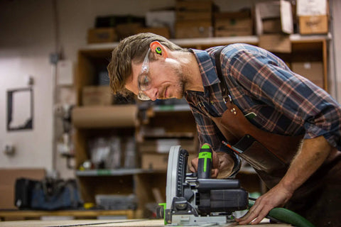 Man using power tool in workshop wearing True Wireless Buds With Heat Activated Memory Foam Eartips For 22 dB Noise Reduction