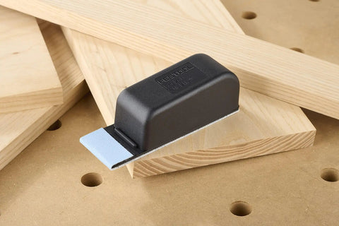Pocket StickFix Hand Sanding Block With Quick Change Hook And Loop System on wooden surface
