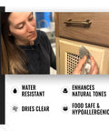 Person applying hemp wood oil finish to cabinet, highlighting water resistance and food-safe qualities.