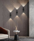 Battery Powered Wall Sconce Dual Pack With Motion Sensor on a wall in living room, black finish, showcasing soft lighting