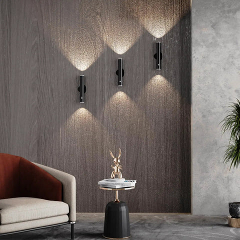 Battery Powered Wall Sconce Dual Pack With Motion Sensor on a wall in living room, black finish, showcasing soft lighting