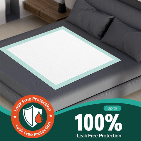 Ultra Thick Disposable Bed Pads With Rock Solid Adhesive Strips 30 X 36 Inches 50 Count on a dark bed covering.
