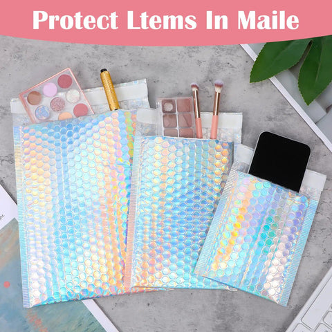 60 Pack Holographic Bubble Mailers Dope Waterproof Self Seal Foil Glitter Glamour Shipping Envelopes In 3 Sizes shown with makeup and phone