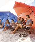 Group relaxing under Oversized 9 Foot UPF 50 Plus Umbrella Shelter With Privacy Panels For Sun And Rain Protection at beach