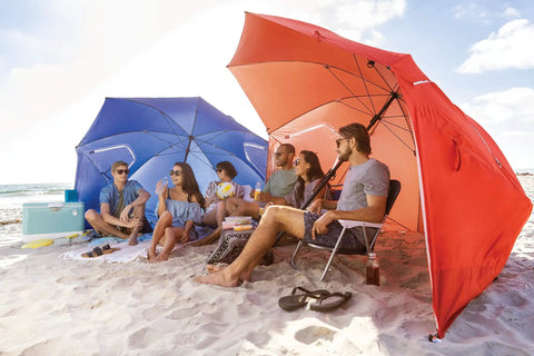 Group relaxing under Oversized 9 Foot UPF 50 Plus Umbrella Shelter With Privacy Panels For Sun And Rain Protection at beach