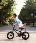 Child riding 16 Inch Kids Bike For Ages 4 And Up, BMX Style Youth Bicycle with Training Wheels on a street