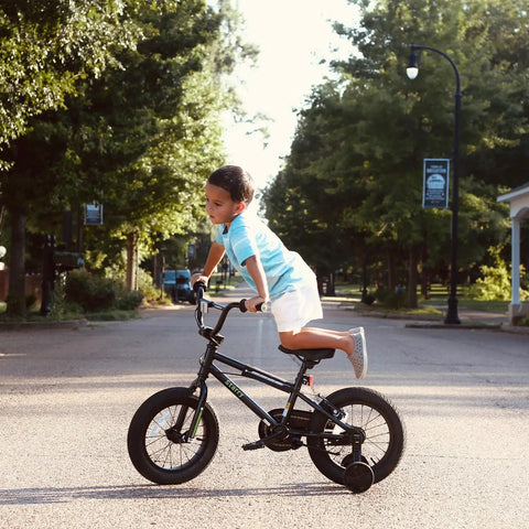 Child riding 16 Inch Kids Bike For Ages 4 And Up, BMX Style Youth Bicycle with Training Wheels on a street