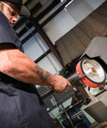 Person using Heavy Duty 2 By 72 Square Belt Grinder Featuring Slick Variable Speed Drive for metal shaping.