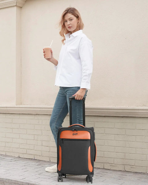 Person with Lightweight 20 Inch Softside Carry On Luggage With Four Spinner Wheels Airline Approved 22 By 14 By 9 TSA Lock Telescoping Handle