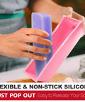 Person popping soap out of Rectangular Soap Mold Kit With Cutter For DIY Soap Making, 42oz Flexible Silicone Loaf Mold With Wooden Box And Stainless Steel Wavy And Straight Scrapers, Complete Craft Set For CP And MP Soaps