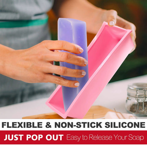 Person popping soap out of Rectangular Soap Mold Kit With Cutter For DIY Soap Making, 42oz Flexible Silicone Loaf Mold With Wooden Box And Stainless Steel Wavy And Straight Scrapers, Complete Craft Set For CP And MP Soaps