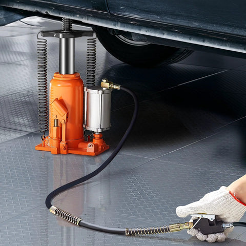 Orange air-hydraulic bottle jack 20-ton installed under a vehicle with air pump and control hose