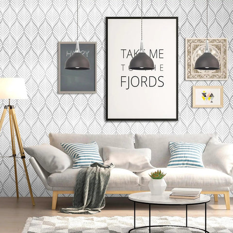 Living room with silver gray peel and stick wallpaper featuring modern boho leaf design, framed art, and cozy sofa setup.