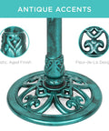 Close-up of 28 Inch Pedestal Bird Bath With Fleur De Lis Accents, showing resin pedestal, green antique finish.