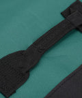 Close-up of handle on green 20 Slot Knife Roll Bag For Pros And Home Cooks Premium Canvas Knife Case Kitchen Travel Gear Durable Roll Up Organizer.