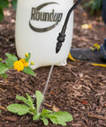 2 Gallon Lawn And Garden Sprayer For Controlling Insects And Weeds Or Cleaning Decks And Siding With Comfort Grip And Lockable Trigger And Three Nozzles For All Your Home And Garden Spraying Needs being used on weeds