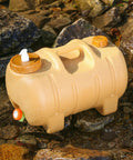 Camping Water Container With Spigot And Soap Dispenser Portable Water Storage Jug in yellow on rocky terrain.