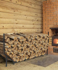 Six Foot Outdoor Firewood Rack Heavy Duty Metal Wood Holder Built For Up To 880 Lbs next to indoor fireplace on brick wall