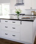 Kitchen island with Matte Black Cabinet Handles Five Pack Three And A Half Inch Center To Center Classic Pulls on white drawers