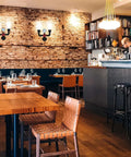 Retro Industrial Wall Lamp Sconce With Two Lights Vintage Water Pipe Design in cafe interior on brick wall