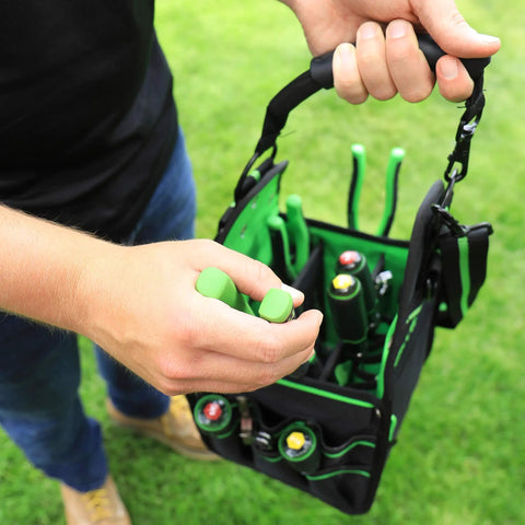 Person carrying HVAC Tool Tote Bag With 27 Pockets And 13 Inch Size, Water Resistant Pro Carryall For HVACR Tools, Black And Green.