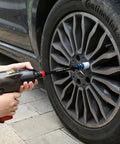 Half-Inch Drive 8 Inch Color-Coded Torque Extension Bar Set, 10-Piece in use with impact wrench on car wheel lug nut