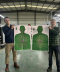 Two people holding Double Sided Shooting Targets 5 Pack 23 By 35 Inches Full Size B-27E PROS And FBI-Q Tactical Silhouette in Green.