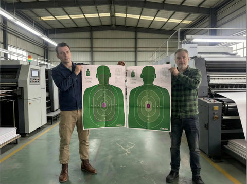 Two people holding Double Sided Shooting Targets 5 Pack 23 By 35 Inches Full Size B-27E PROS And FBI-Q Tactical Silhouette in Green.