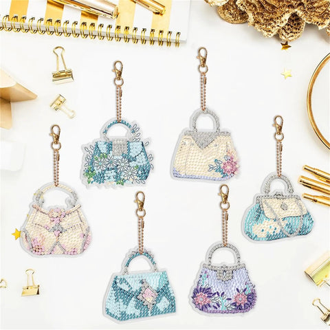 Six Piece Double Sided Diamond Painting Keychain Kit Set for Beginners and Adults, bag-shaped ornament set on desk.