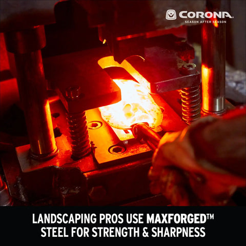 Red-hot steel being forged in industrial press for landscaping tools