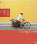 A Damn Fine First Edition Travel Book By Tony Wheeler Checking Out The Real Grind Of Rickshaw Drivers Across Agra Hanoi Macau Singapore Hong Kong Manila With 192 Pages on a bicycle against a vibrant yellow wall.