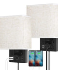 Bedside Wall Lamp Set Of 2 Plug In Sconce Lights With USB Charging Ports And AC Outlet Brushed Nickel Modern Wall Sconces For Bedroom And Living Room E26 LED Bulbs Included, linen shade and USB connections in use, phones charging.